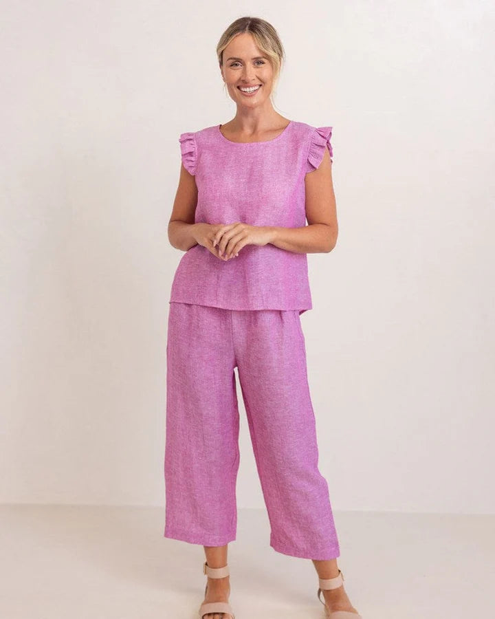 See Saw women’s top in raspberry, featuring soft ruffle sleeves and a decorative button-back design made from a linen-viscose blend.