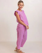 See Saw women’s top in raspberry, featuring soft ruffle sleeves and a decorative button-back design made from a linen-viscose blend.