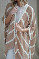 The Rust & White Stripes Carmen Cardigan by Rustic Linen is currently available at Rawspice Boutique.