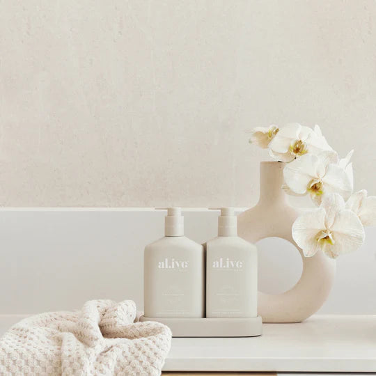 Alive Sea Cotton & Coconut Hand & Body Duo in Illuminated White featuring a 500ml hand and body wash and 500ml hand and body lotion in interlocking bottles with a matching tray.
