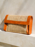 Seoul Clutch in white featuring Indonesian rattan cane webbing with leather trim in a sleek, elegant clutch silhouette.