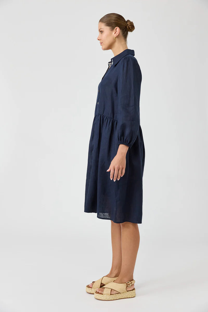 Navy midi shirt dress with a button-down front, long balloon sleeves, and a contrast ribbon detail, crafted from luxurious linen for a relaxed yet chic look.