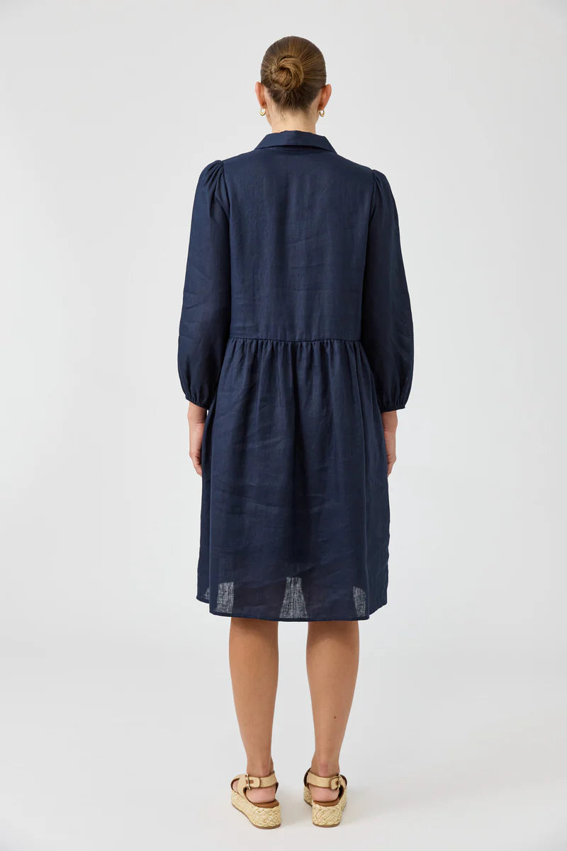 Navy midi shirt dress with a button-down front, long balloon sleeves, and a contrast ribbon detail, crafted from luxurious linen for a relaxed yet chic look.