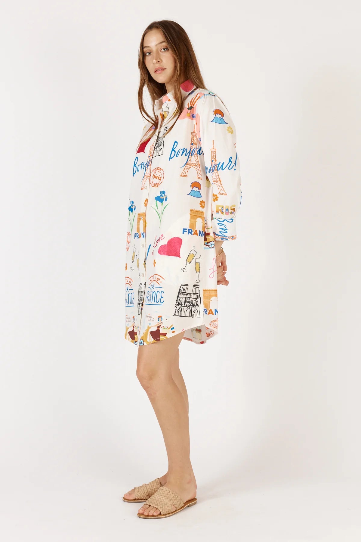 A white Bonjour Shirtmaker dress featuring a classic collared neckline, diamante buttoned cuffs, and side pockets for a stylish and comfortable look.
