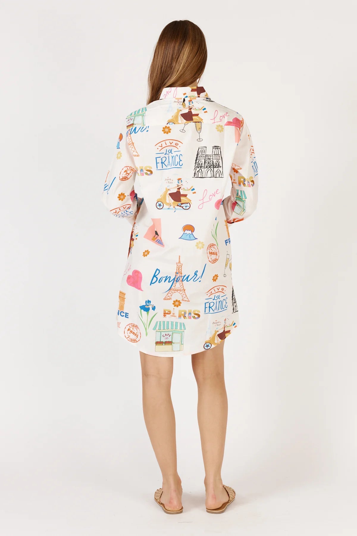 A white Bonjour Shirtmaker dress featuring a classic collared neckline, diamante buttoned cuffs, and side pockets for a stylish and comfortable look.
