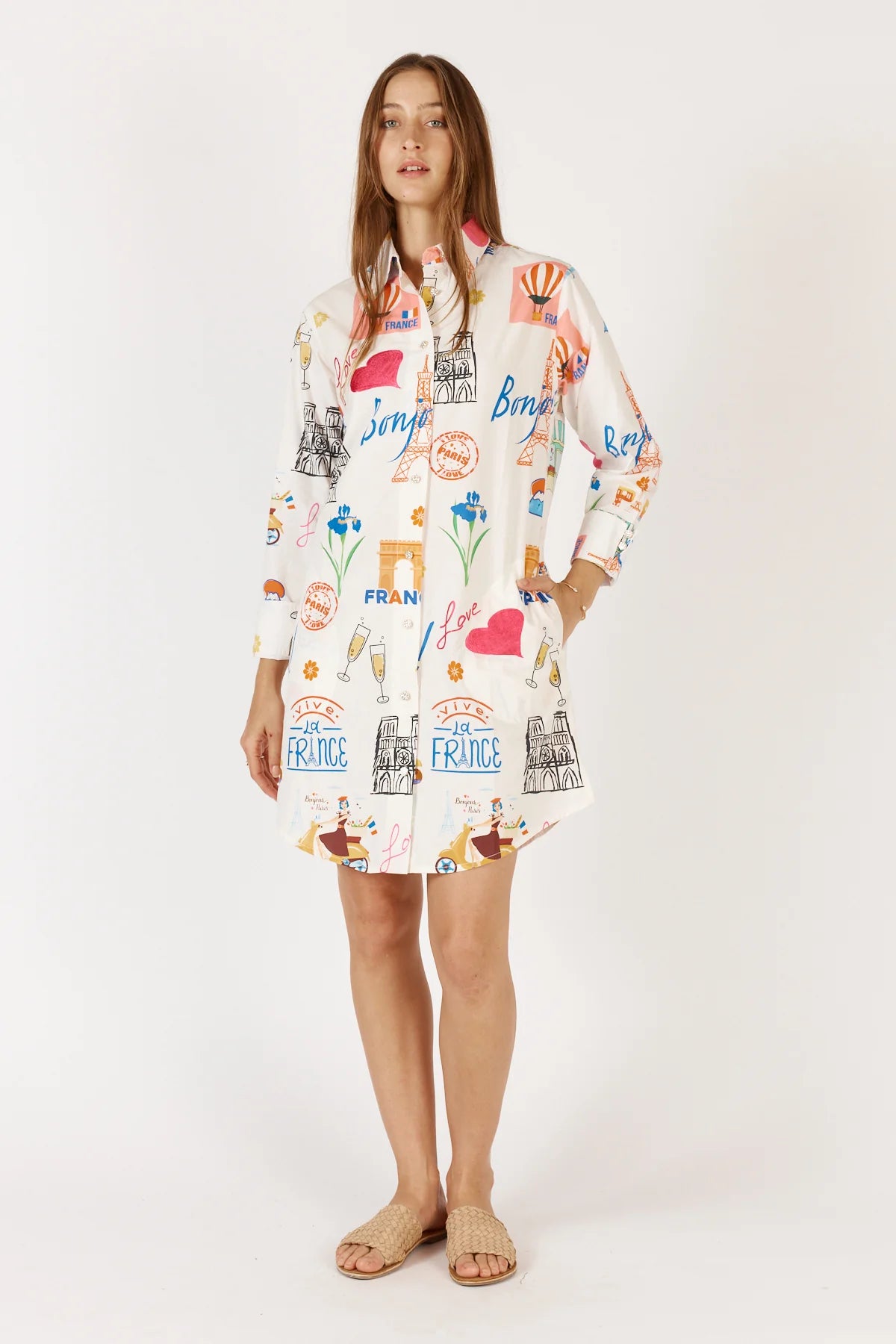 A white Bonjour Shirtmaker dress featuring a classic collared neckline, diamante buttoned cuffs, and side pockets for a stylish and comfortable look.
