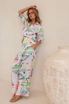 High-waisted wide-leg linen pants in vibrant Marrakesh print, featuring a breathable feel and flowing, relaxed silhouette.