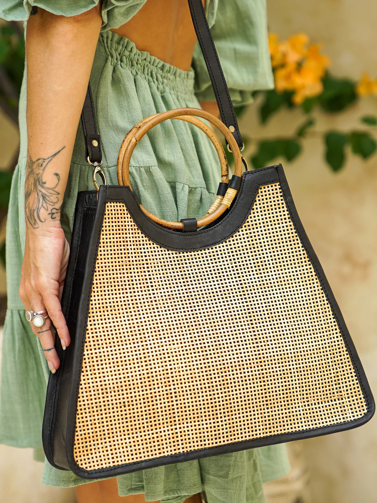 Singapore Bag in black featuring natural rattan weaving with genuine leather detailing in a structured summer handbag design.