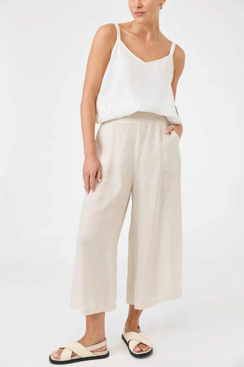 Studio Crop Pant in Tusk, made from breathable linen, featuring a wide-leg cropped fit, elasticated waistband, side pockets, and a relaxed, flowy silhouette.