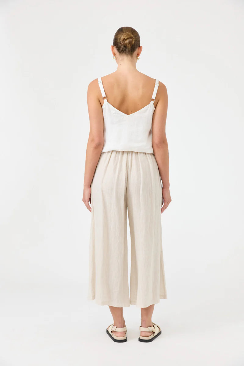Studio Crop Pant in Tusk, made from breathable linen, featuring a wide-leg cropped fit, elasticated waistband, side pockets, and a relaxed, flowy silhouette.