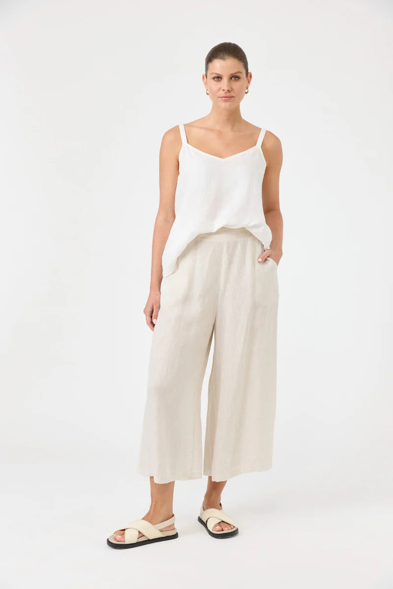 Studio Crop Pant in Tusk, made from breathable linen, featuring a wide-leg cropped fit, elasticated waistband, side pockets, and a relaxed, flowy silhouette.