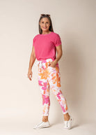 A woman modelling the Brittny Elastic Waist Pants in Sunset Orange by Imagine Fashion