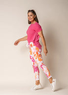 A woman modelling the Brittny Elastic Waist Pants in Sunset Orange by Imagine Fashion