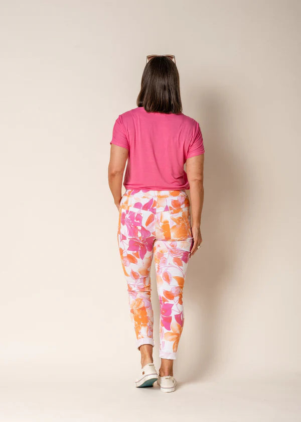 A woman modelling the Brittny Elastic Waist Pants in Sunset Orange by Imagine Fashion from behind