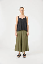 Studio Tank in ebony with square V-neck, adjustable straps, relaxed fit, and soft hem in a lightweight fabric.