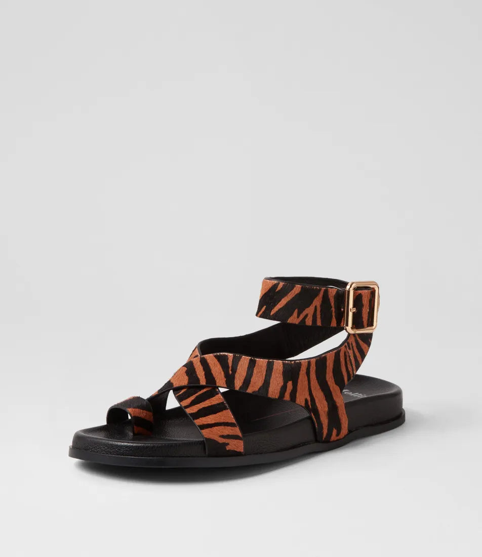  The Huiro Black Tan Zebra Pony Sandals by Mollini are currently available at Rawspice Boutique. 