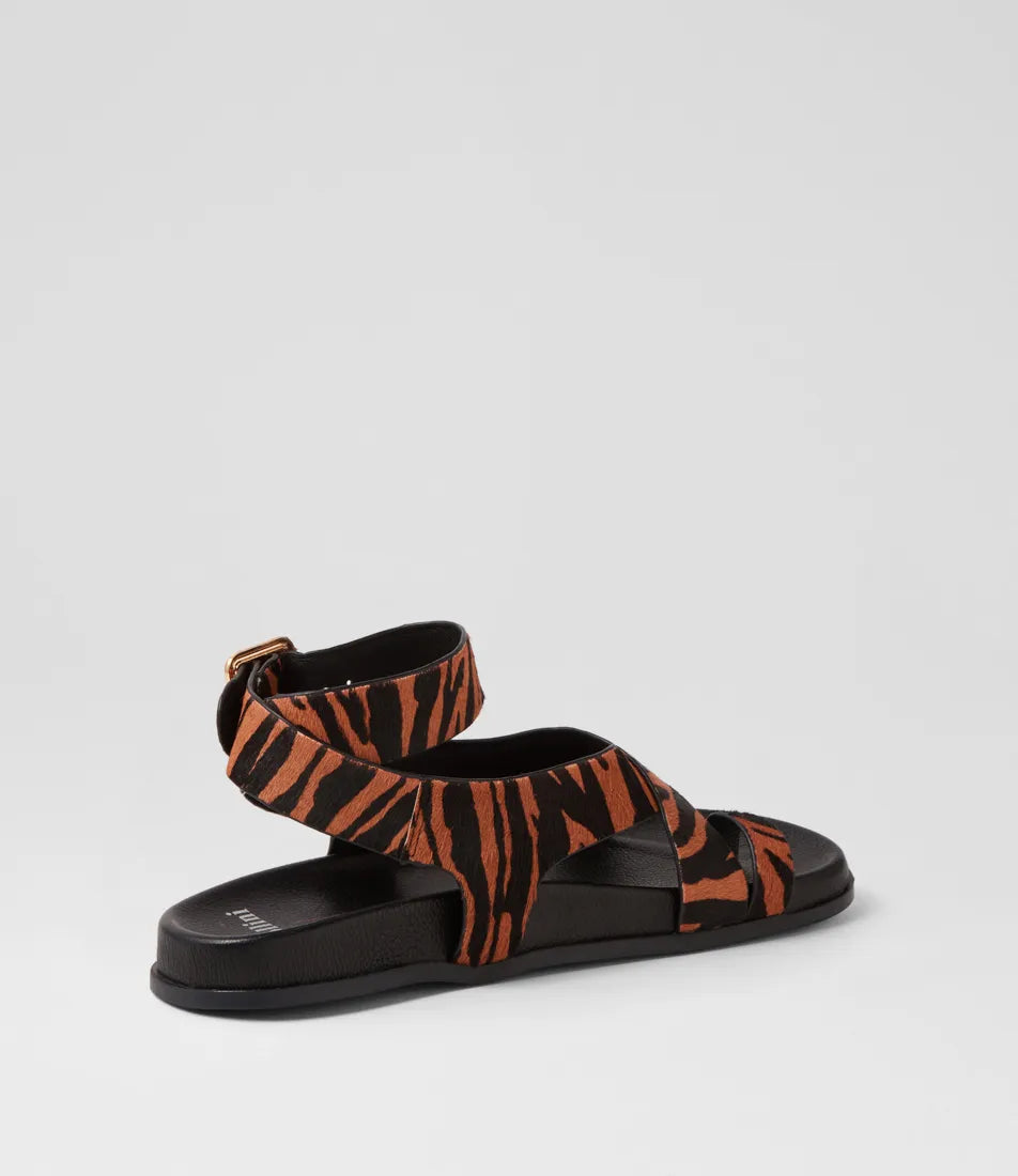  The Huiro Black Tan Zebra Pony Sandals by Mollini are currently available at Rawspice Boutique. 