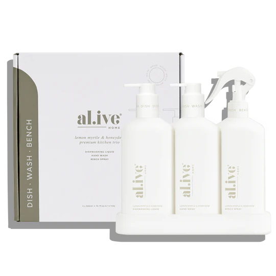 The Alive Kitchen Trio Set in Lemon Myrtle & Honeydew, featuring Dishwashing Liquid, Bench Spray, and Hand Wash, arranged neatly in a sleek, custom tray. The set is displayed against a clean, bright countertop, showcasing the crisp white bottles and elegant design, with soft green and yellow hues evoking the fresh, citrusy scent of lemon myrtle and honeydew.