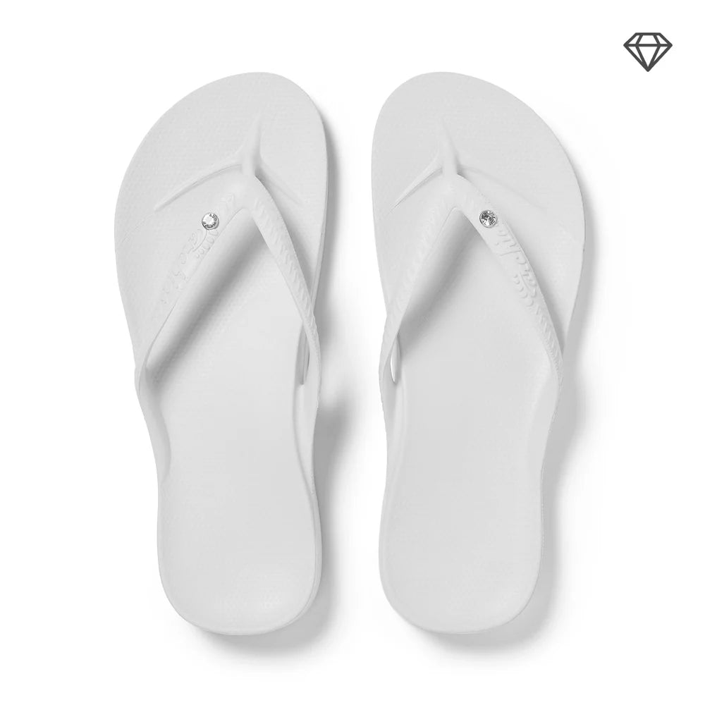 Crystal white arch support thongs with contoured footbeds and ergonomic straps for enhanced comfort and stability