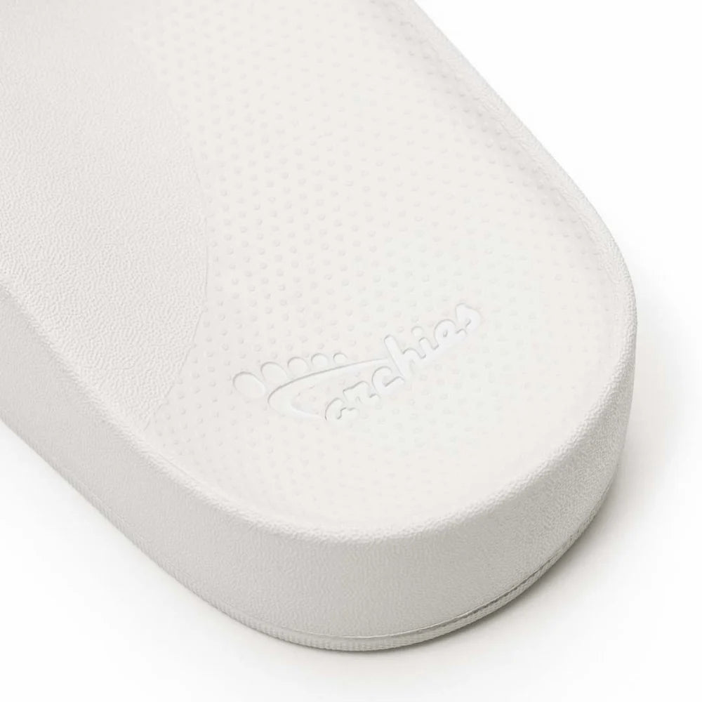 A pair of white arch support slides with contoured footbeds and wide straps, designed for comfort and all-day wear.