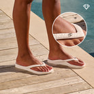 Crystal white arch support thongs with contoured footbeds and ergonomic straps for enhanced comfort and stability.