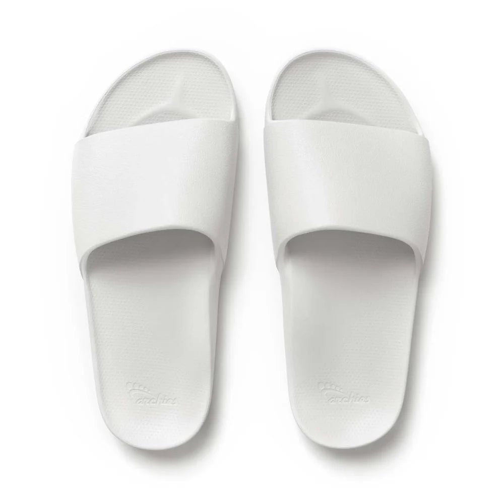 A pair of white arch support slides with contoured footbeds and wide straps, designed for comfort and all-day wear.