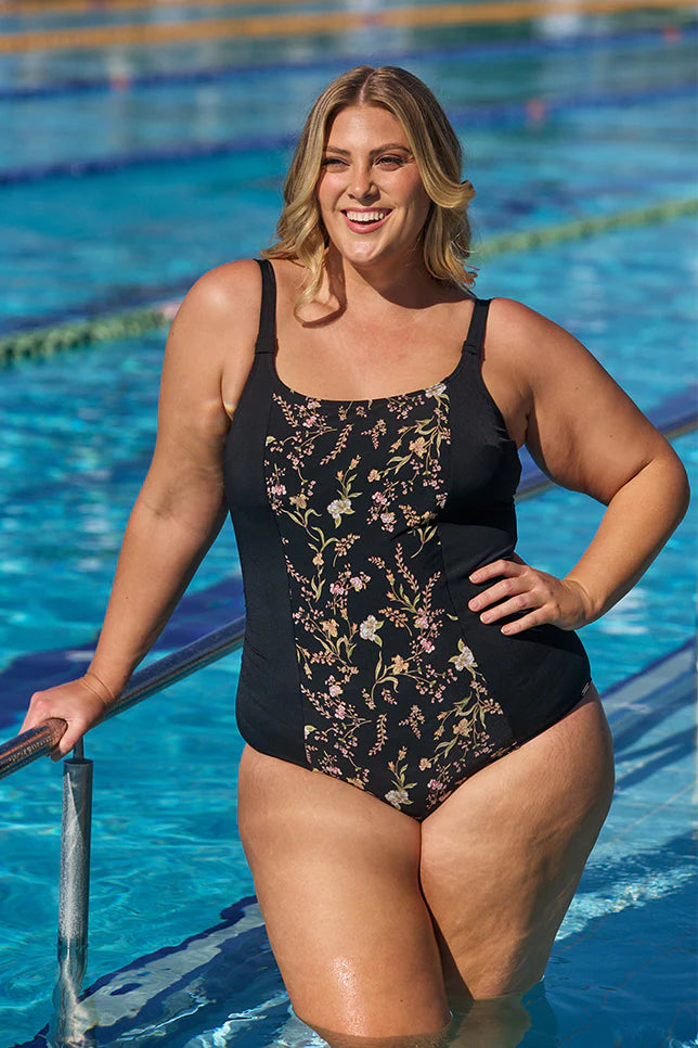 A woman modelling plus size swim wear in the Wildflowers Chlorine Resistant Tank One Piece